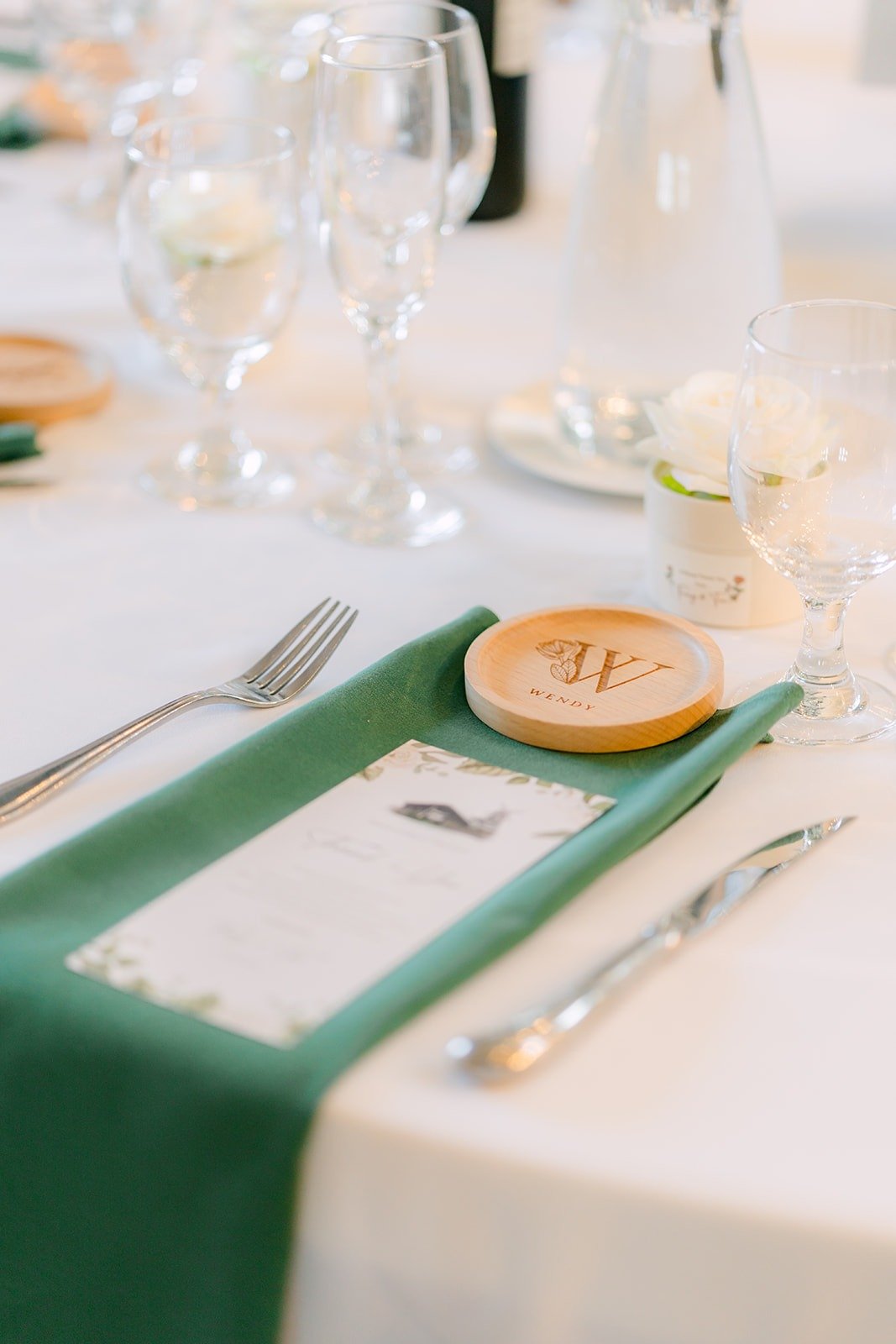 A sage green napkin and gold rimmed place setting