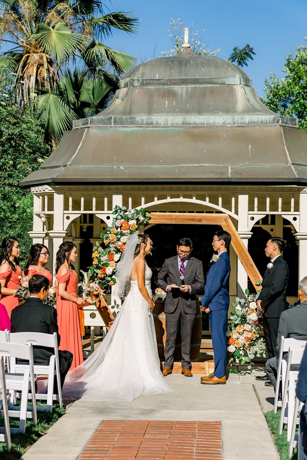 Ariel and Alex at the gazebo with the wedding party around them