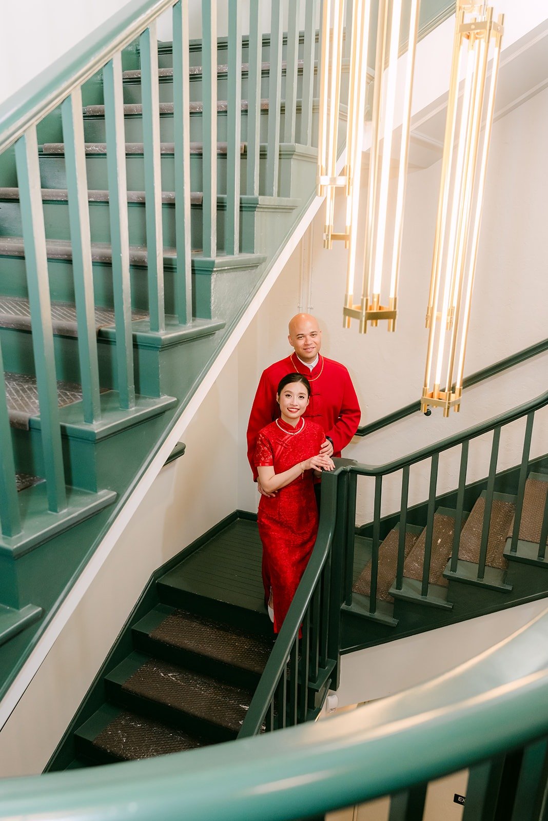 Elisa and Brandon in red on the green staircase