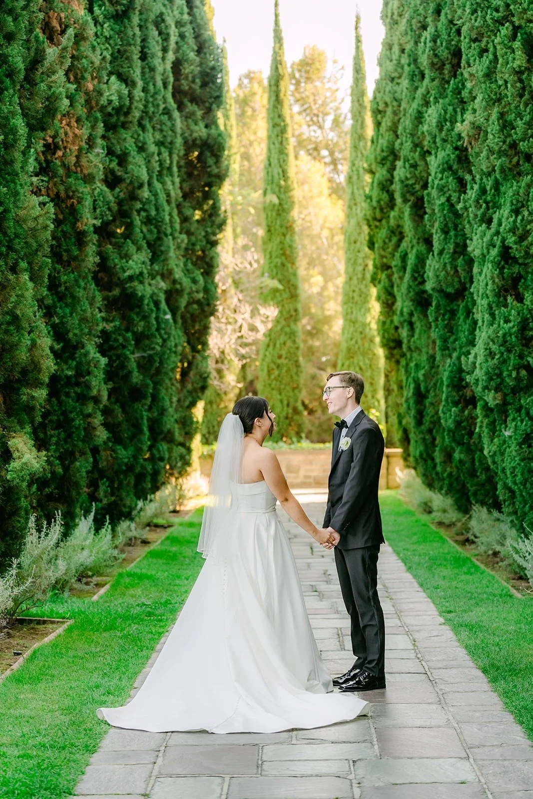 Brianna and Nik walking down the cypress lined path