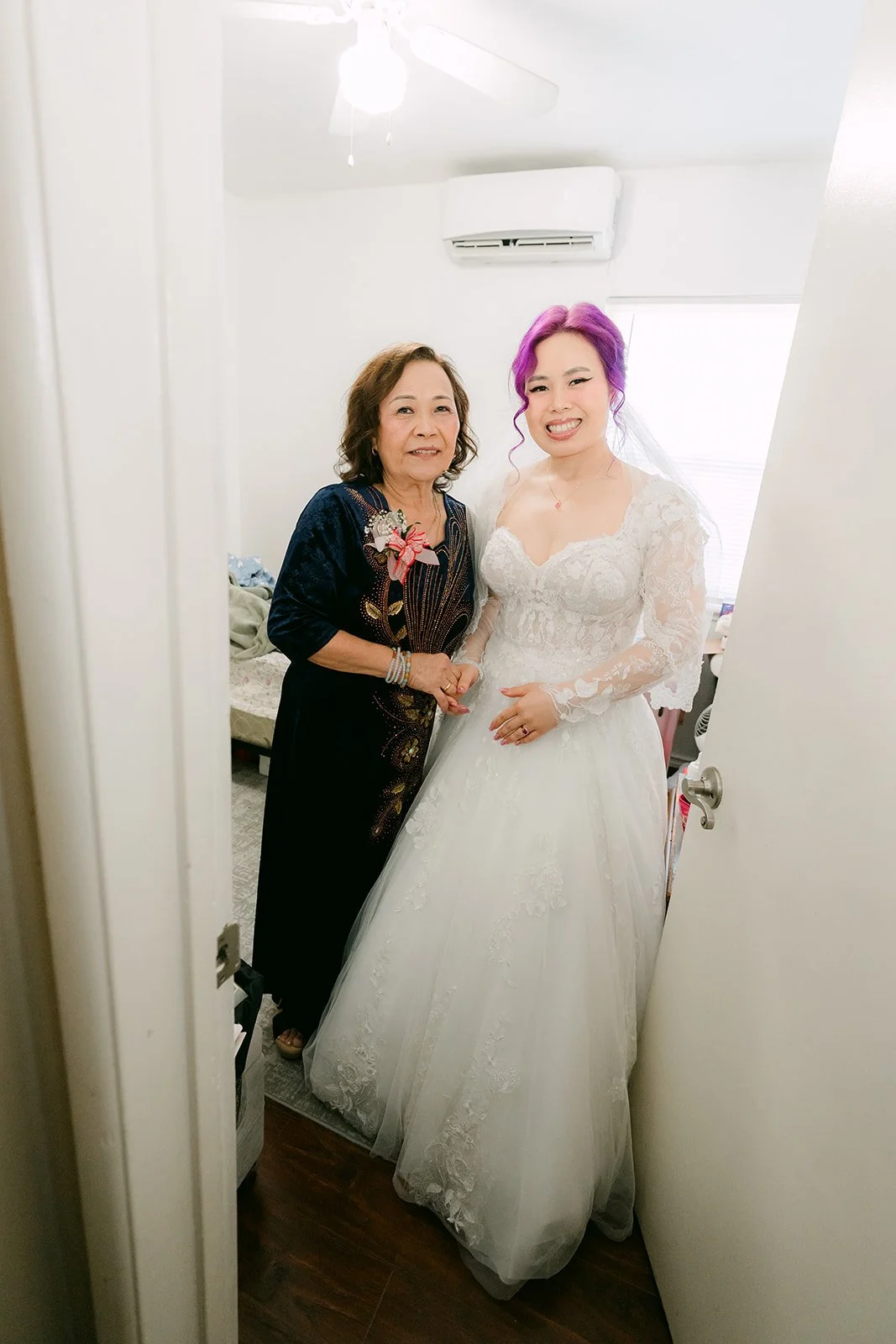 Vanessa in her lace gown with her mom in the hallway.