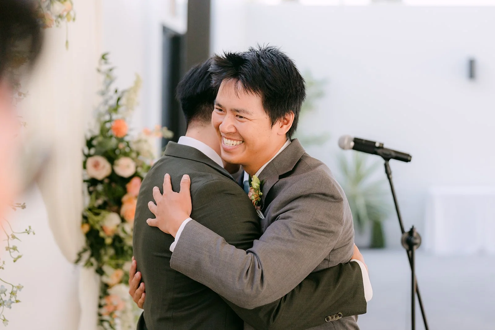 Alex sharing a hug at the front of the ceremony