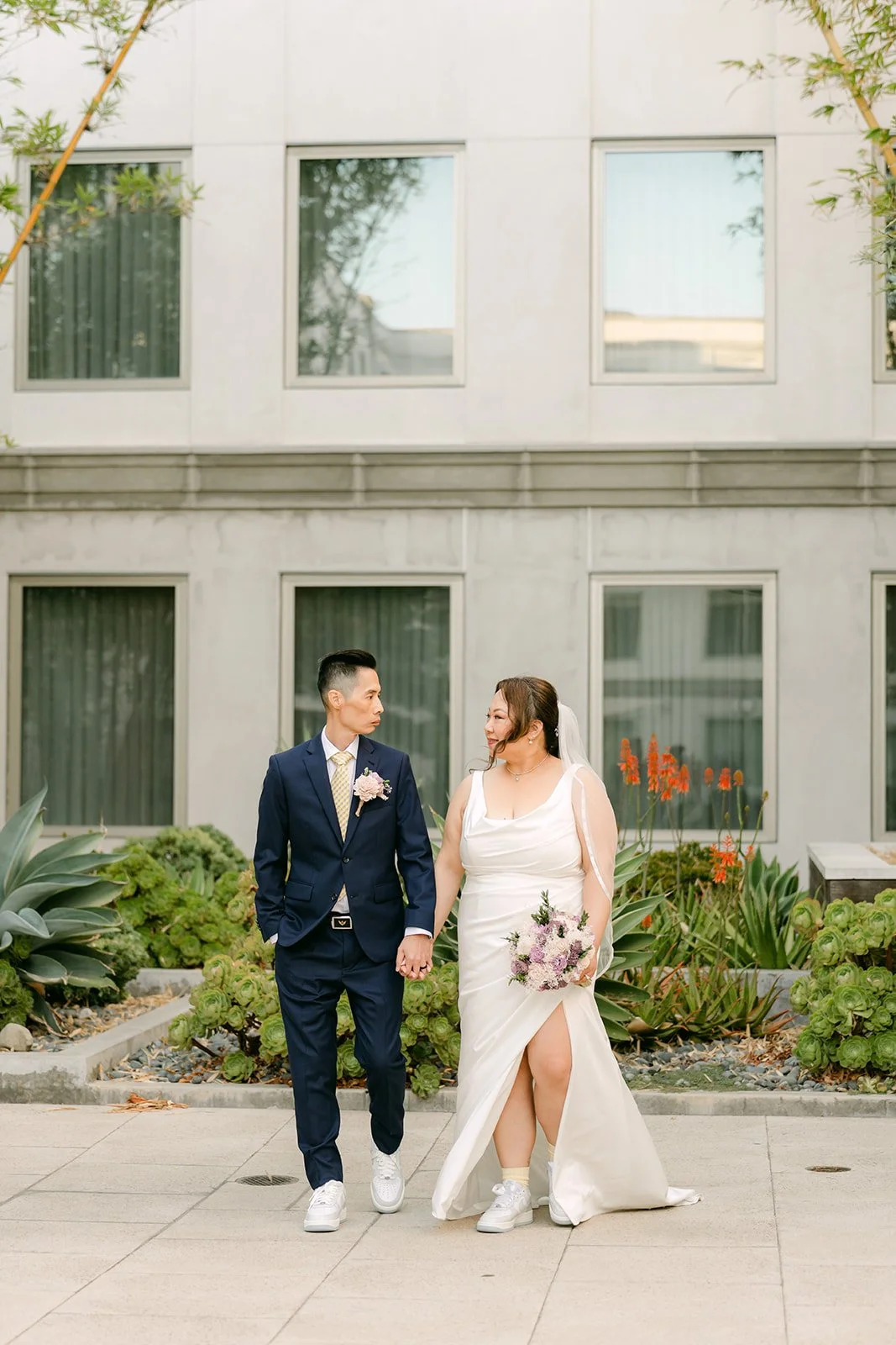 Mai and Bobby laughing on the courtyard.