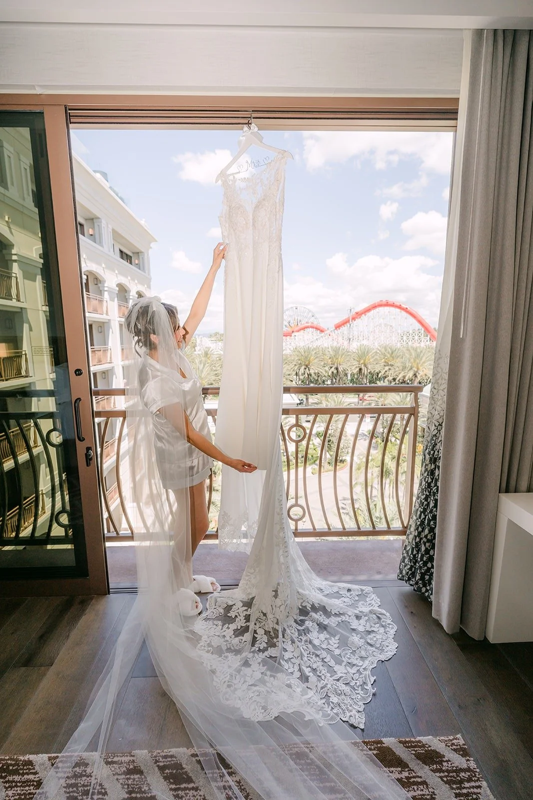 The gown and its long lace train hanging by the balcony door