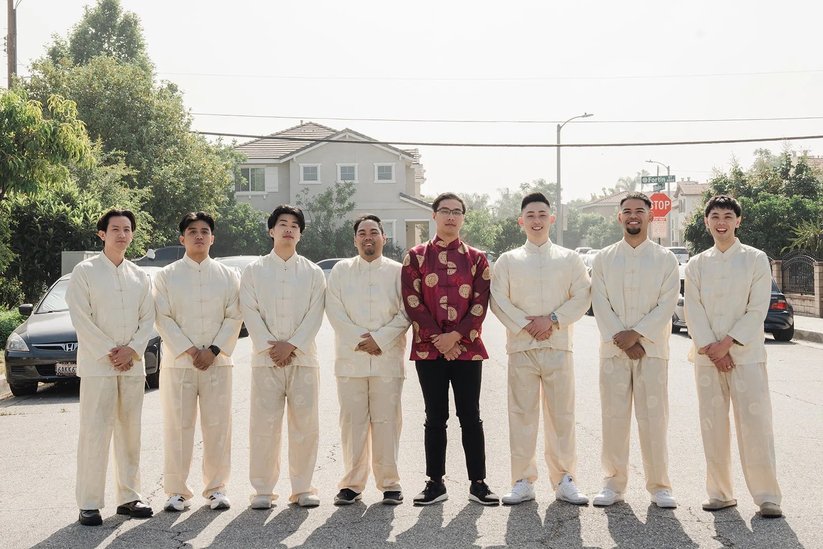 Danny and his groomsmen lined up on the sidewalk.