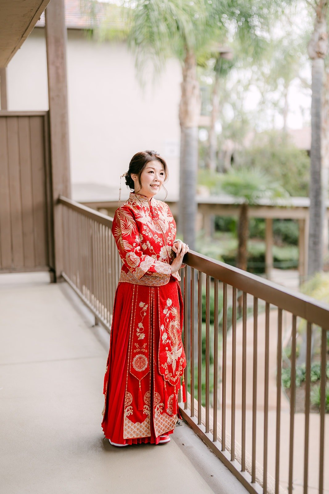 Sochi in her embroidered red dress on the balcony at the DoubleTree Claremont