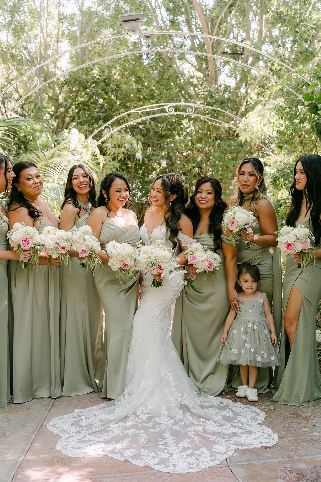 Nicole with her bridesmaids in pistachio green gowns and the flower girl at Eden Gardens.