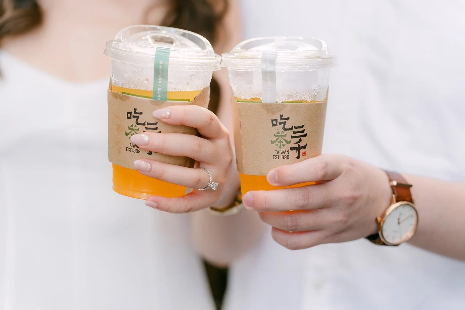 Amanda and San clink their iced teas together inside the Burlington Arcade, photographed by One and Only Production.