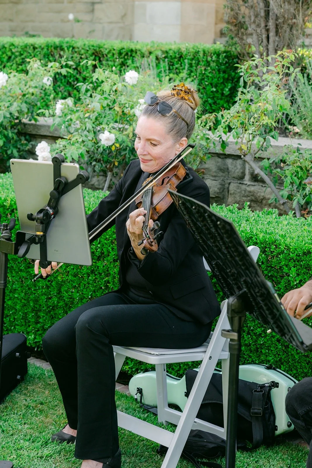 A violinist from the string quartet playing in the garden