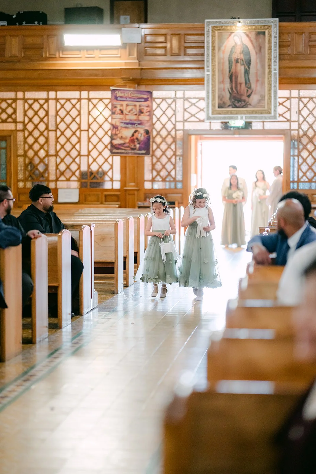 The wedding party walking down the aisle at Our Lady of Guadalupe.