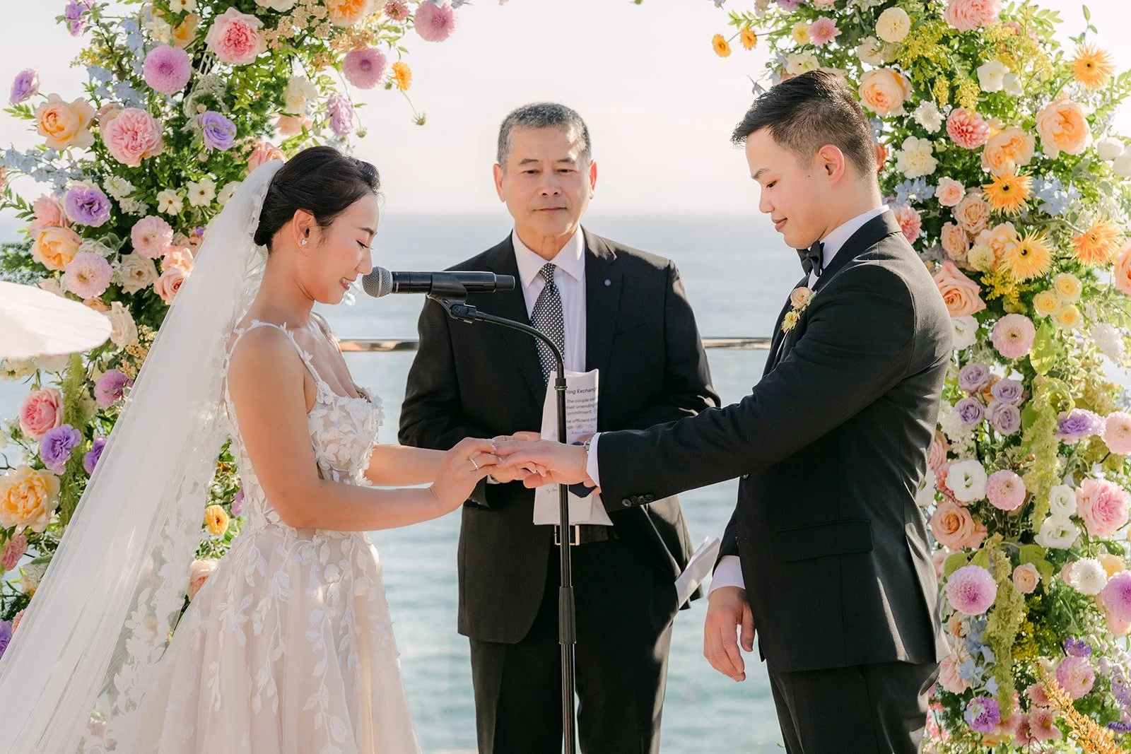 Kylie and Mario holding hands as the officiant speaks