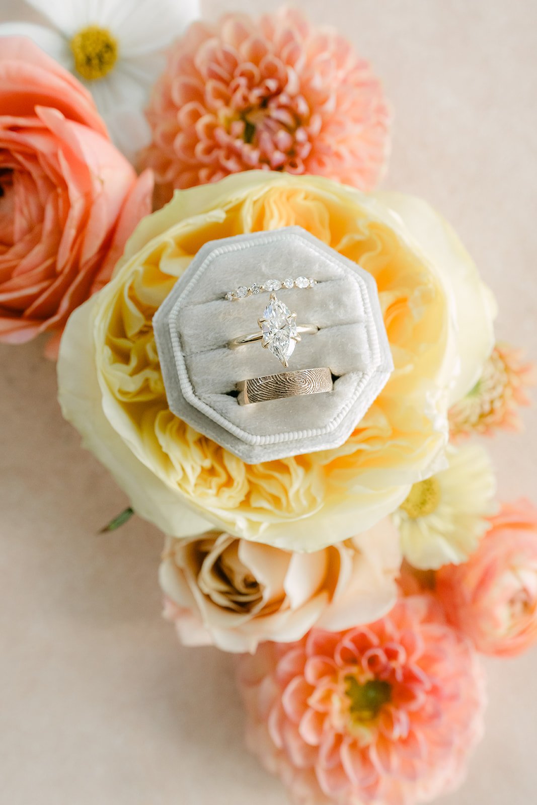 Clarissa's ring in a white ring box among peach dahlias and garden roses