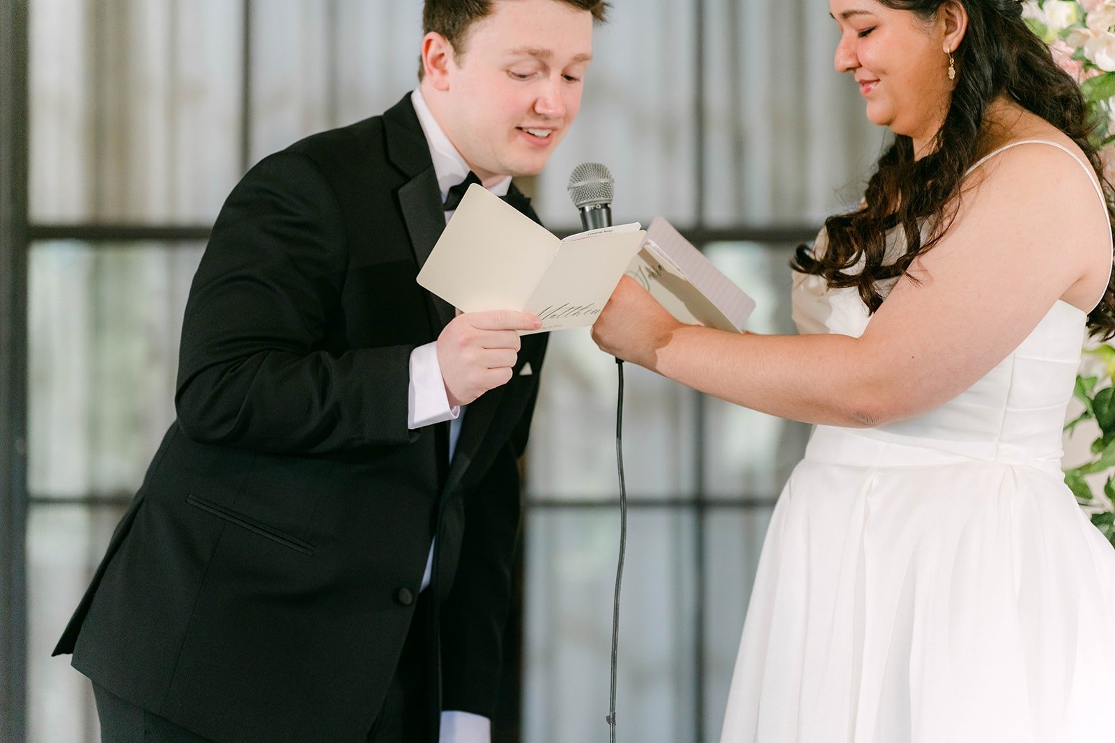 Matthew laughing as he reads his vows to Saira at The Athenaeum at Caltech