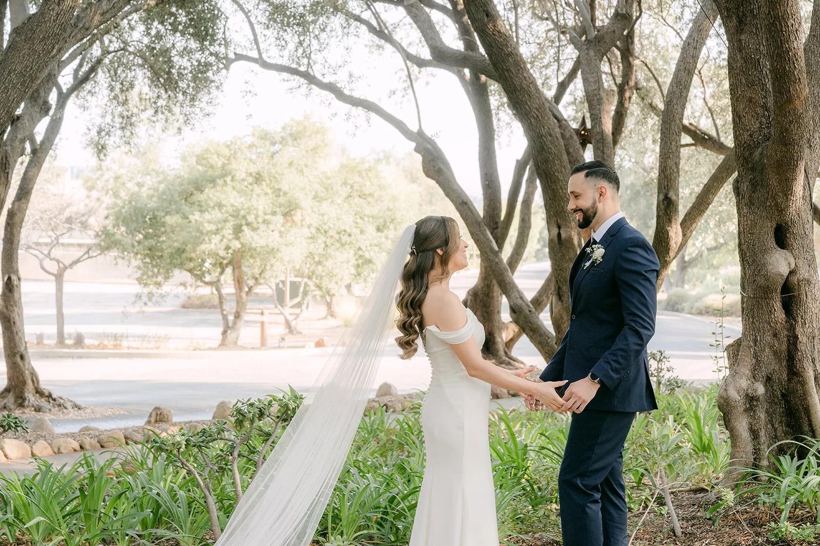 Holding hands during their first look in the Padua Hills olive grove