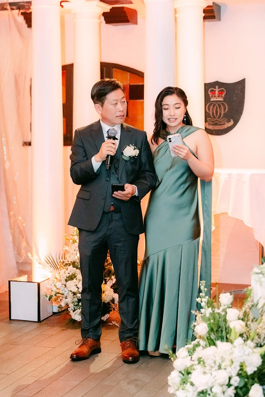 Two members of the wedding party giving a speech together, photographed by One and Only Production