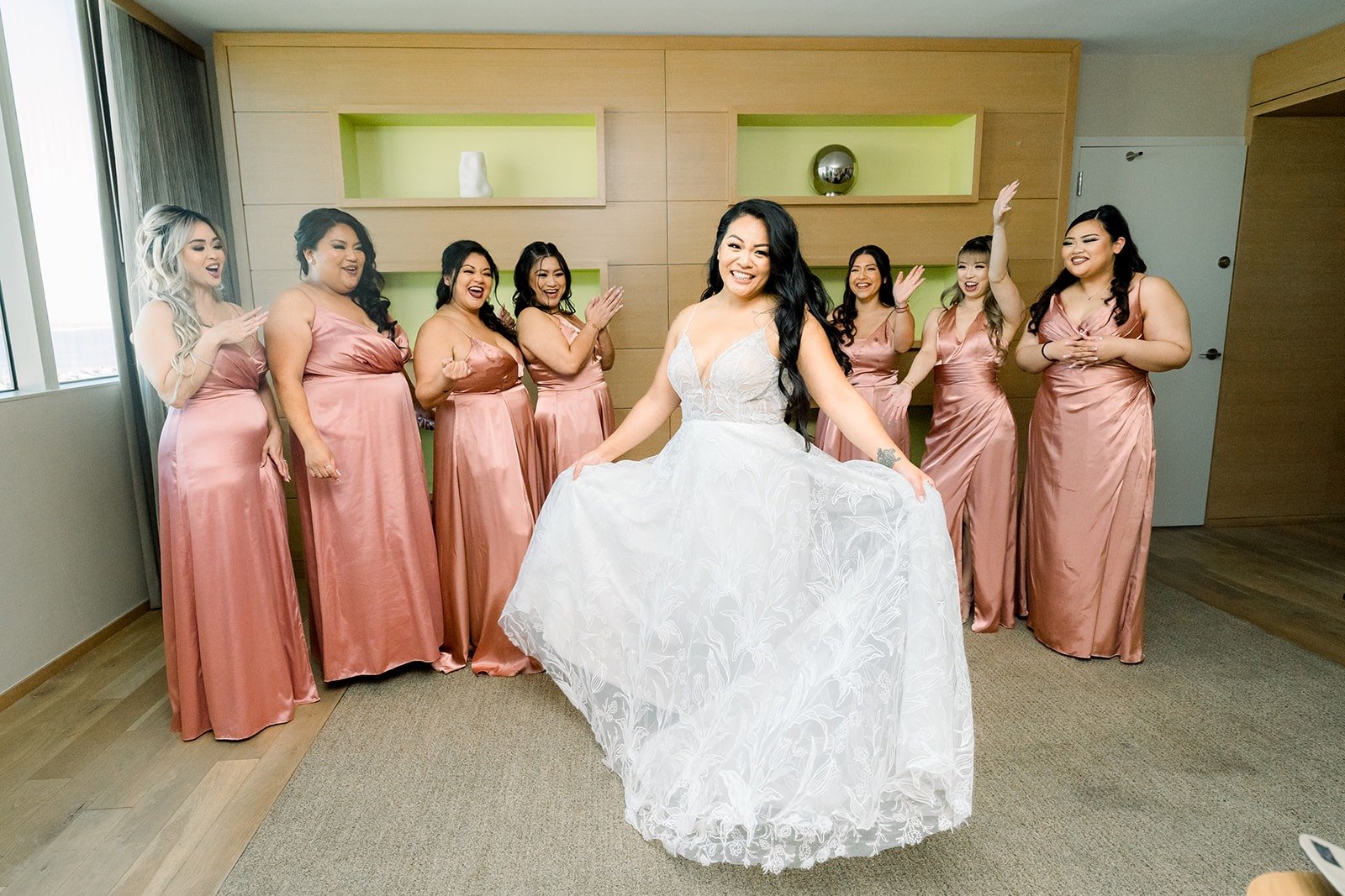 Betsy twirls in her gown as her bridesmaids see her for the first time