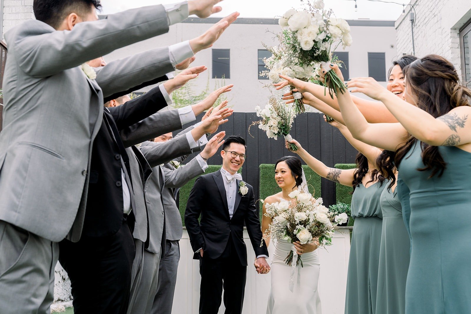 Groomsmen and bridesmaids cheer Cindy and Alex on
