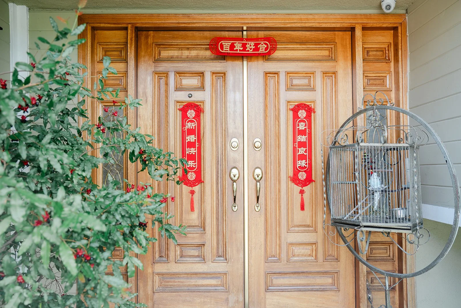 The front doors of Bridgette's parents' home in North Tustin dressed with red couplets.