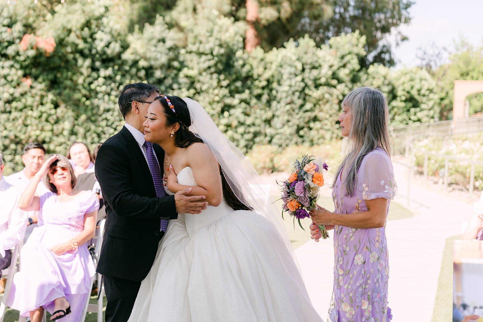 Angela's dad embracing her at the gazebo