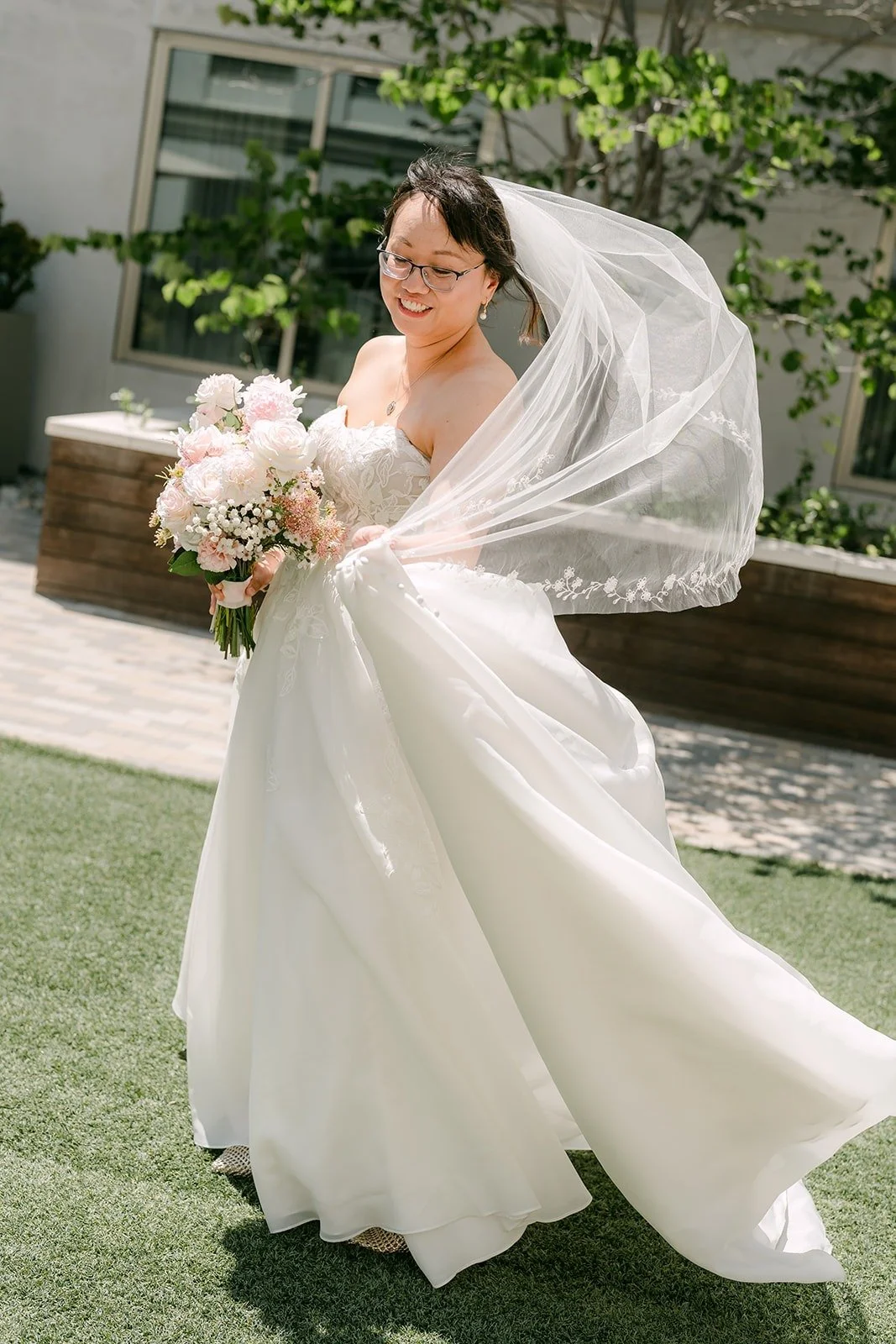 Stella's veil and skirt swirling as she turns in the sunlight