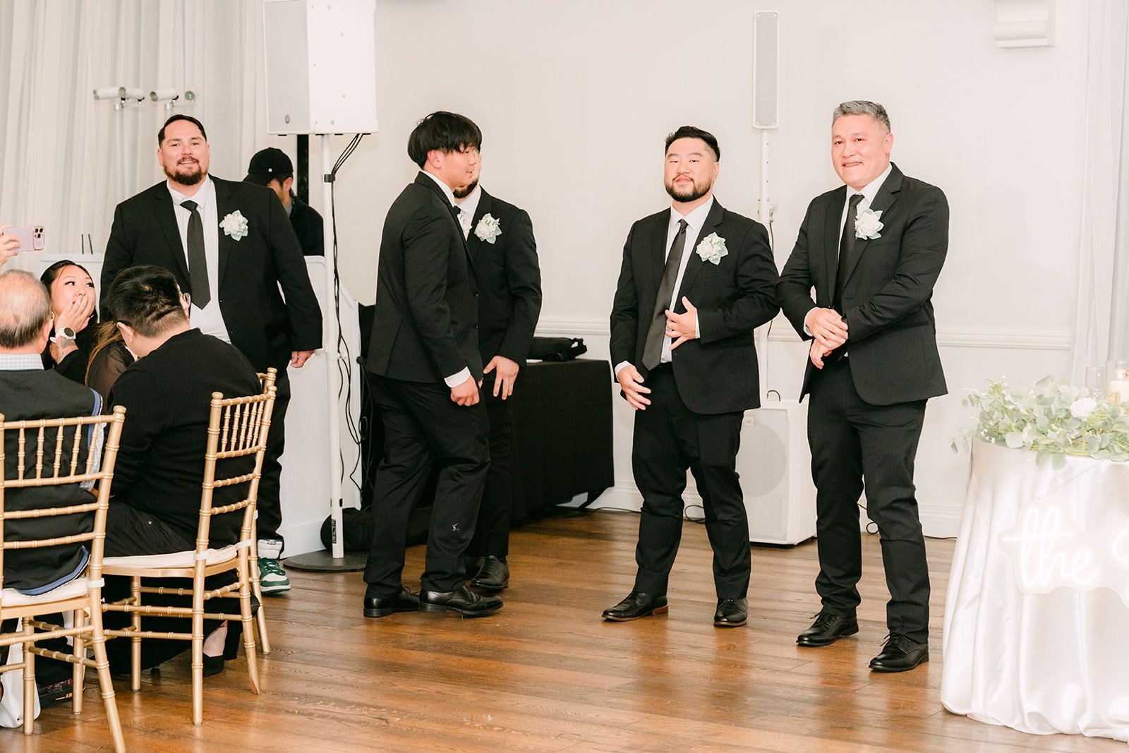 Groomsmen lined up on the dance floor