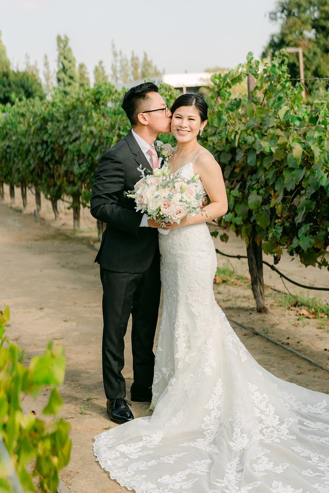Xuemin and Alex smiling in the vineyard at the Turnip Rose