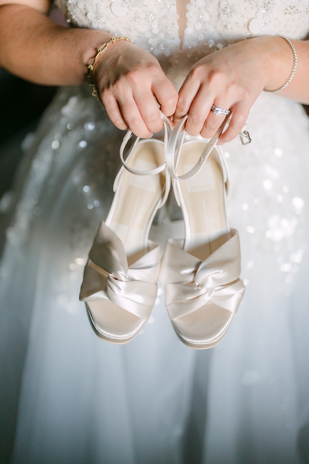 Jennifer holds up her bridal heels over her gown