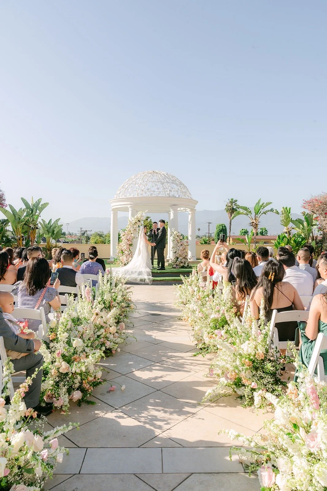Wide view of the ceremony with the white gazebo on the Garden Terrace