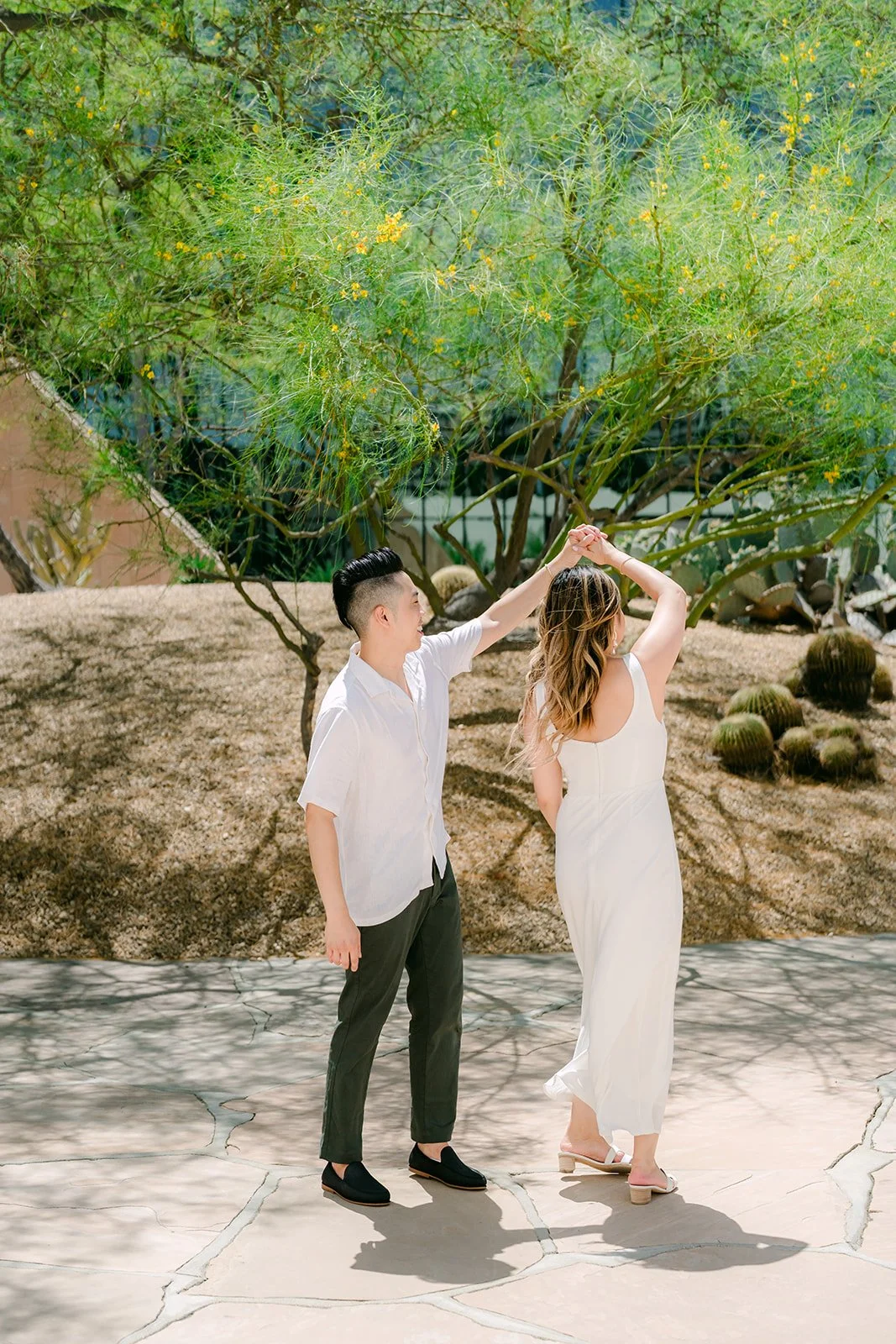 Alan twirls Stephanie in the desert garden.