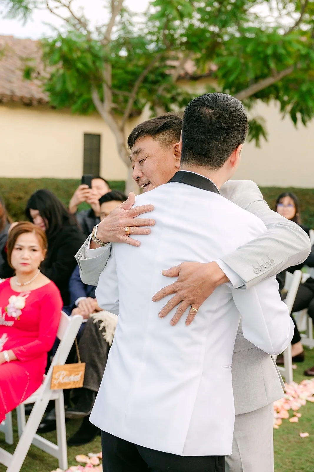 Chungman hugging Ivy's escort at the end of the aisle