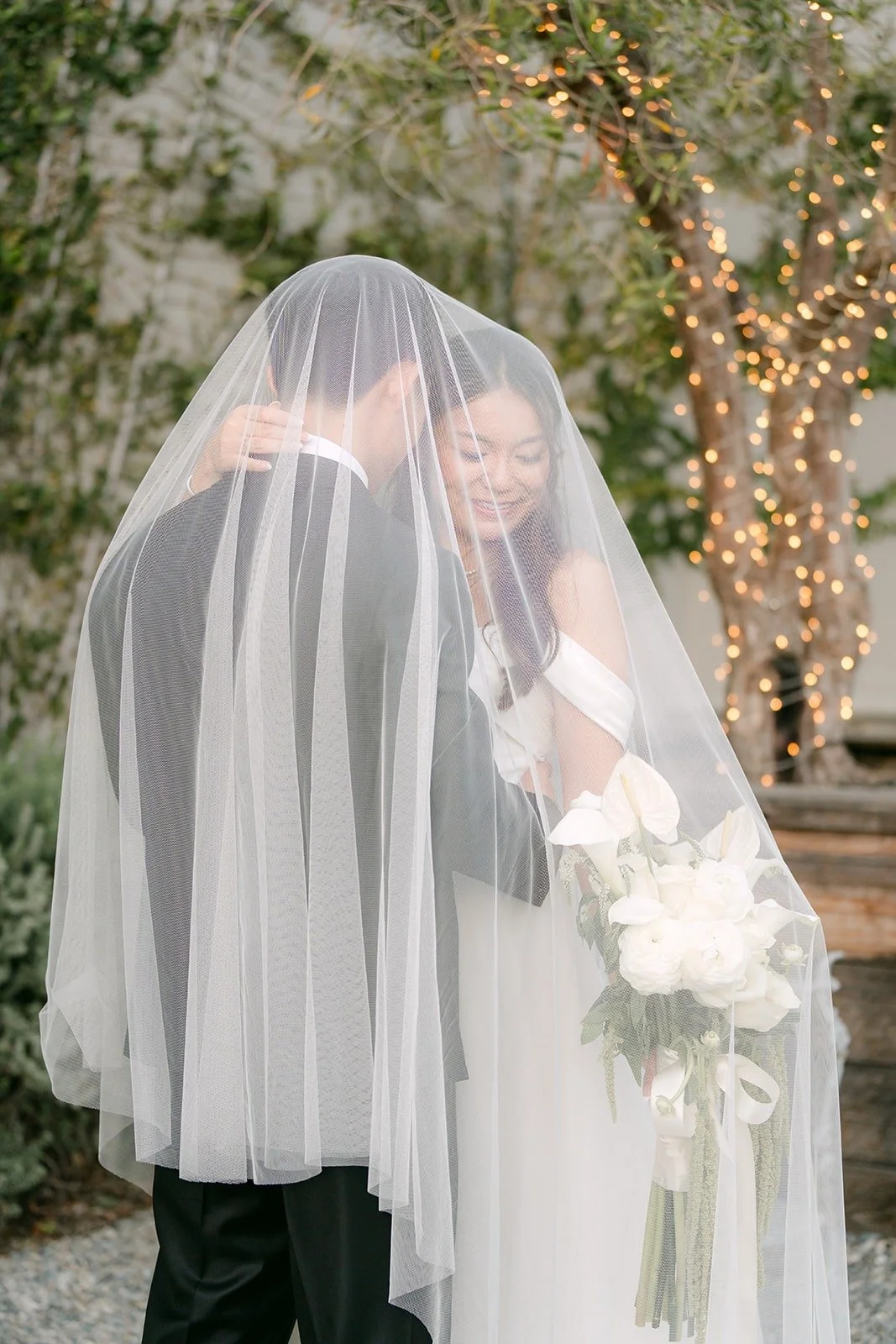 Jadee and Richard kissing under her veil
