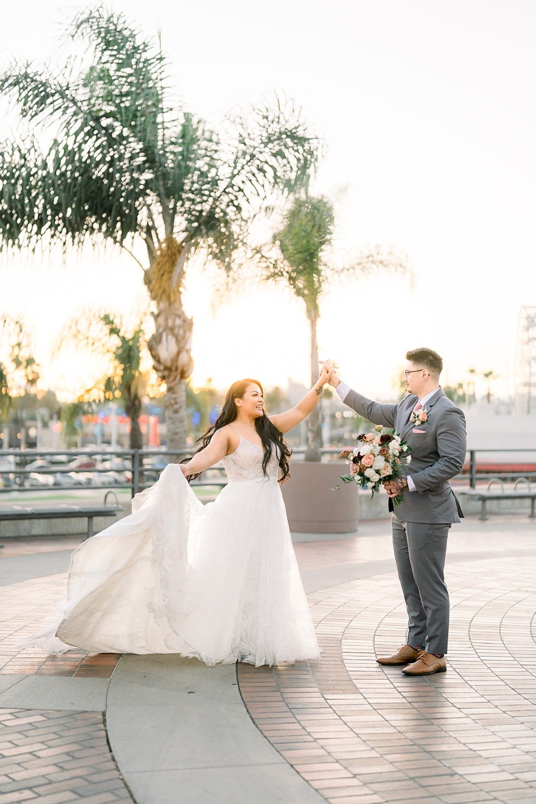 Betsy flips her gown as Mikey watches, photographed by One and Only Production