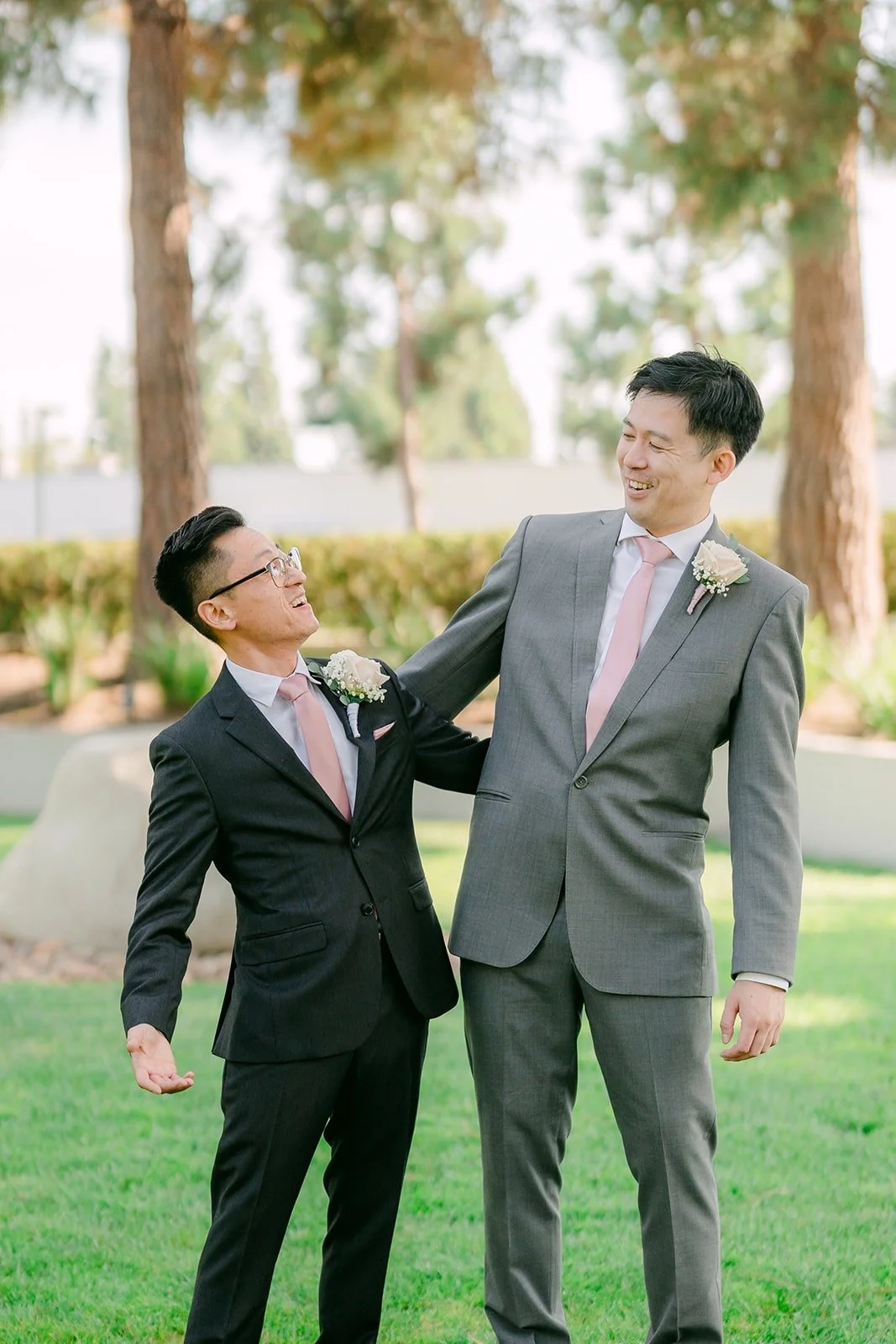 Alex and a groomsman joking around on the lawn