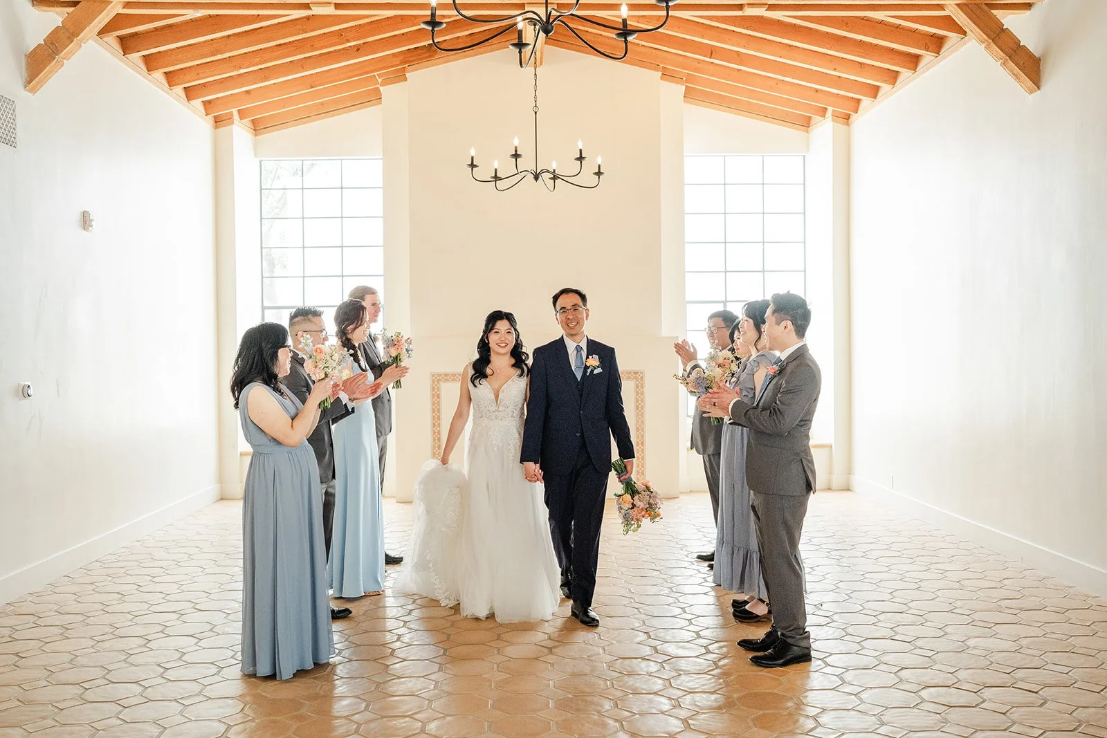 Wedding party cheering with Constance and Lawrence