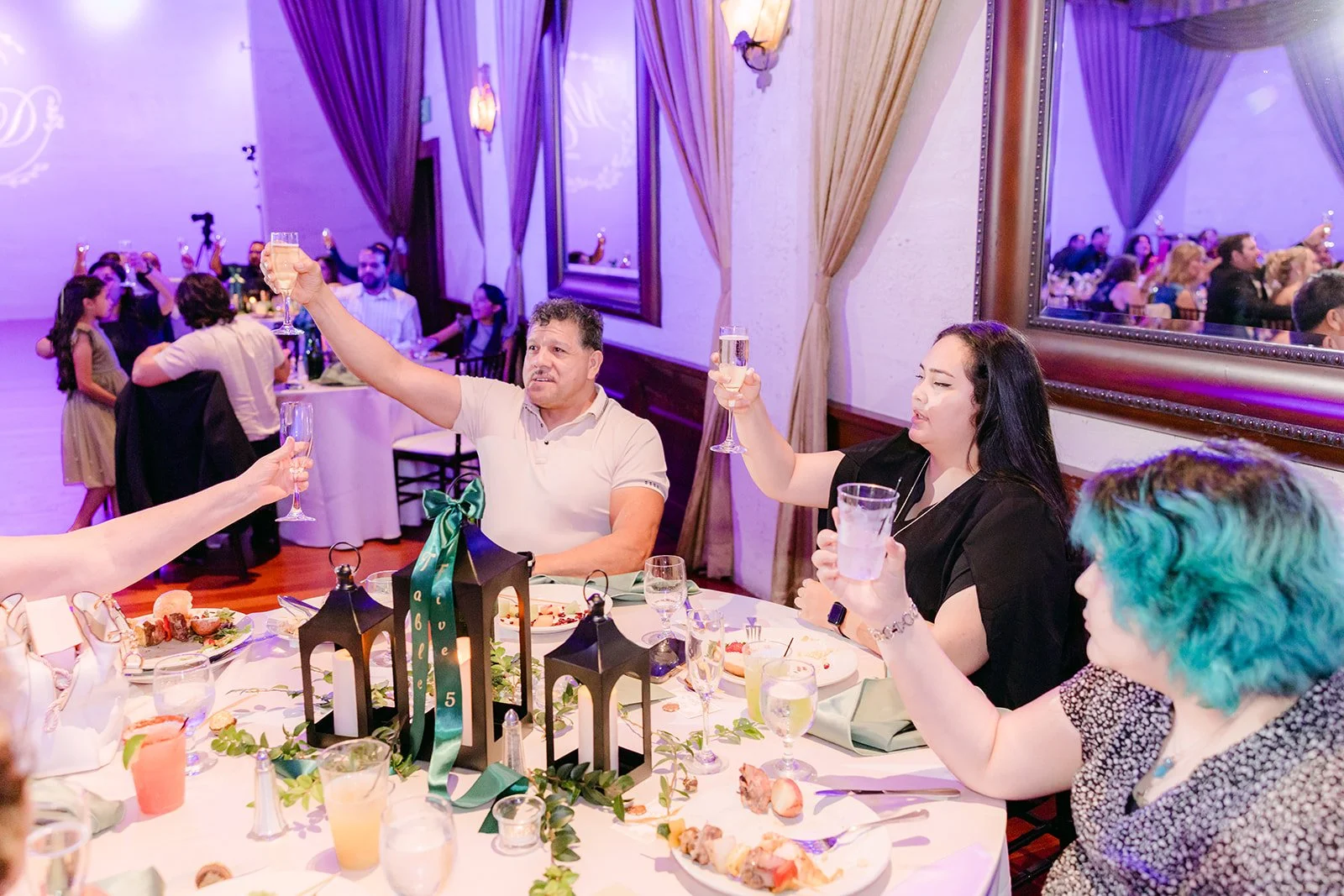 Guests cheering from their table during the cake cutting