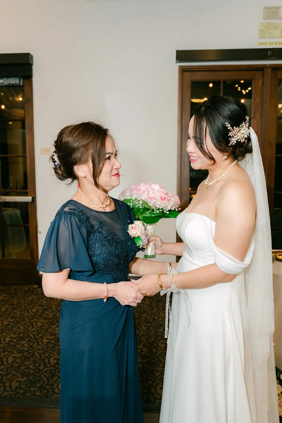 Ivy handing her bouquet to her mom during the bouquet handoff