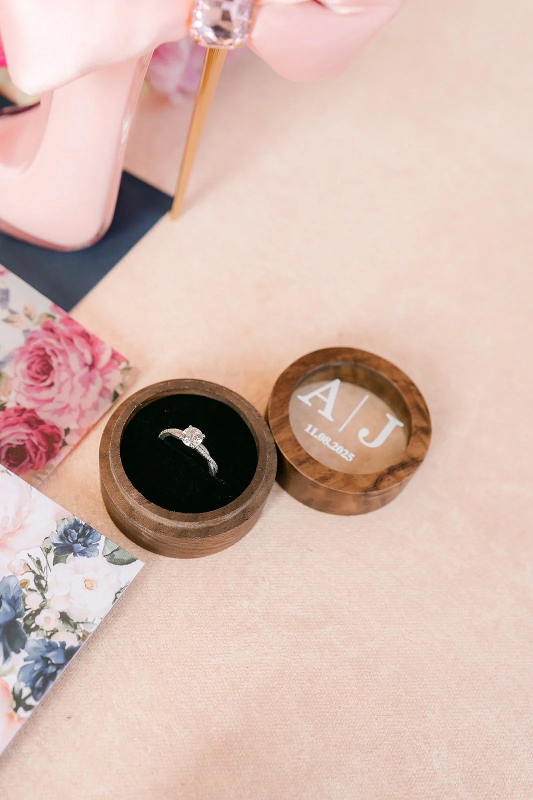 Close up of the engagement ring and wedding band in wooden boxes