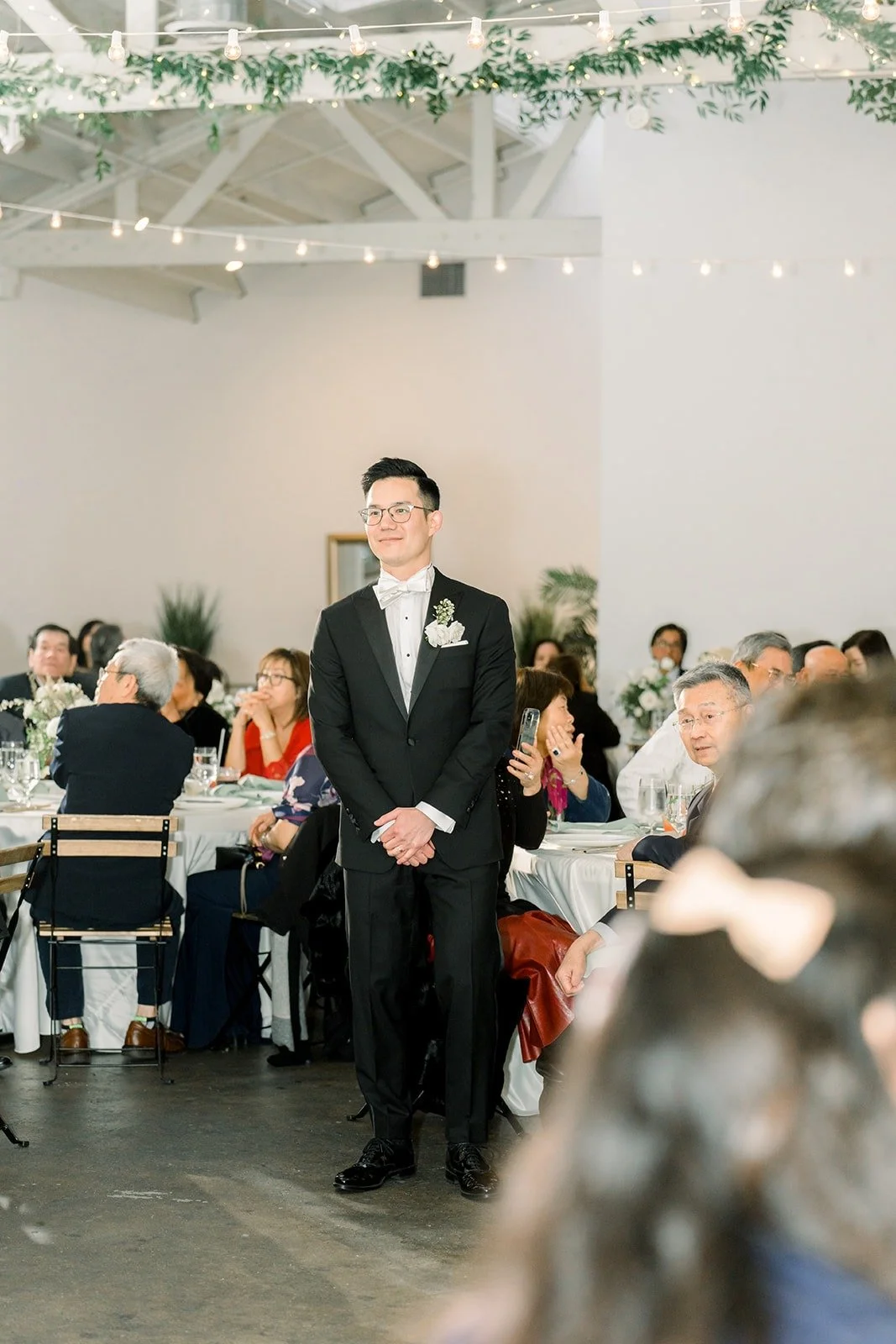 Alex waits on the dance floor as guests look on