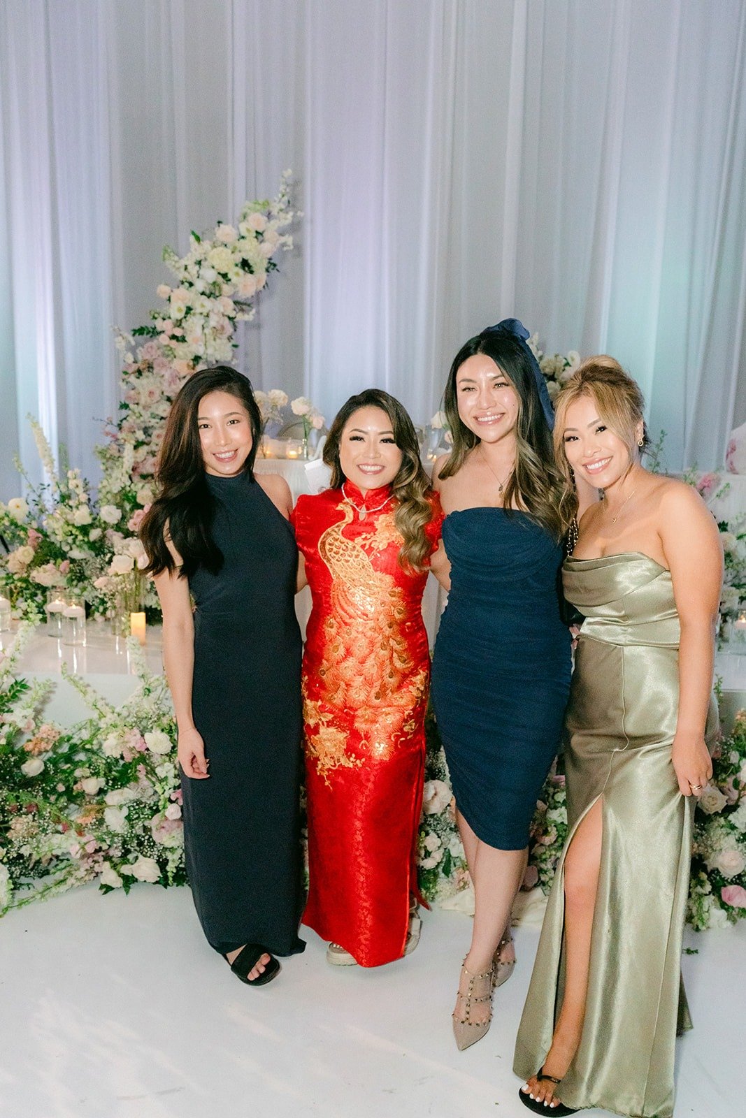Candice with friends by the floral backdrop