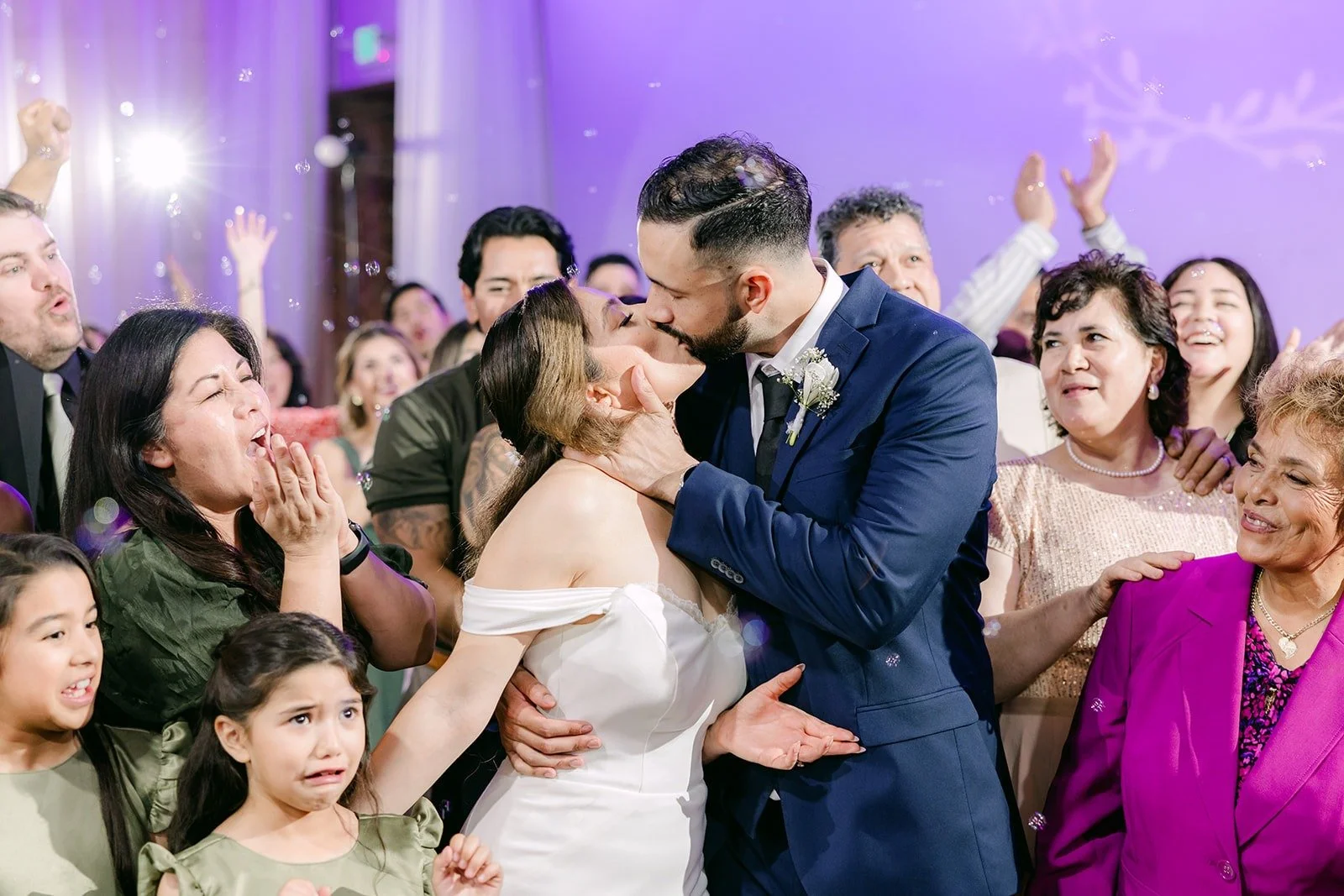 Danny kissing Mariana on a packed dance floor