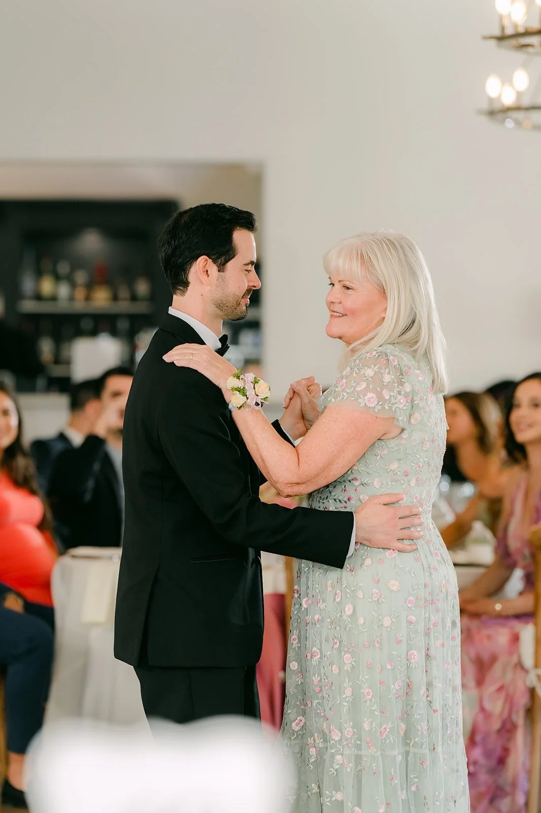 Kevin and his mom sharing a laugh on the dance floor, photographed by One and Only Production