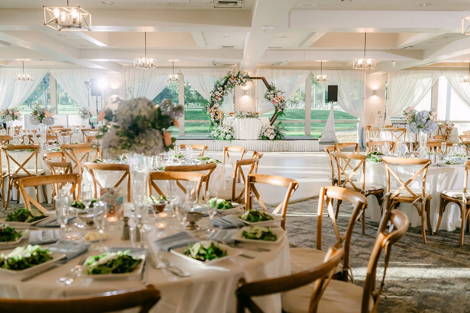 Round tables with blue and blush centerpieces in the Mediterranean Ballroom