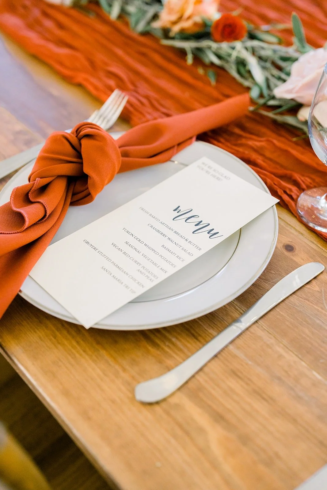 Burnt orange napkin and menu at each place setting
