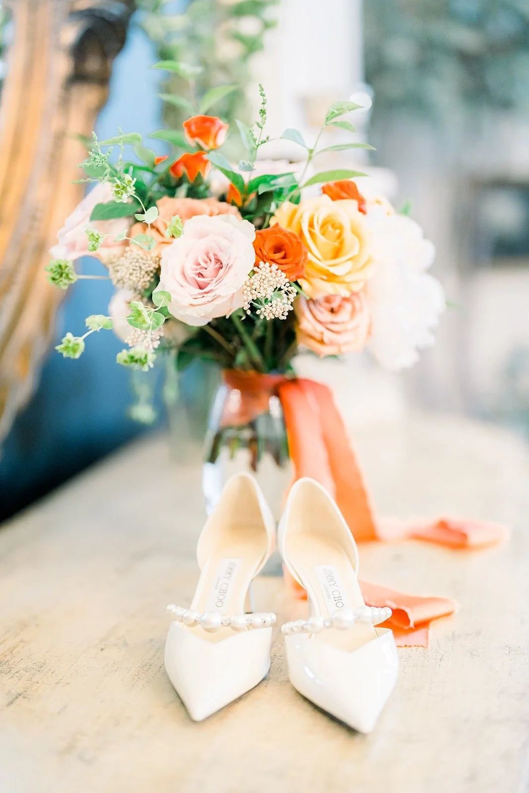 Hannah's ivory heels beside her bouquet
