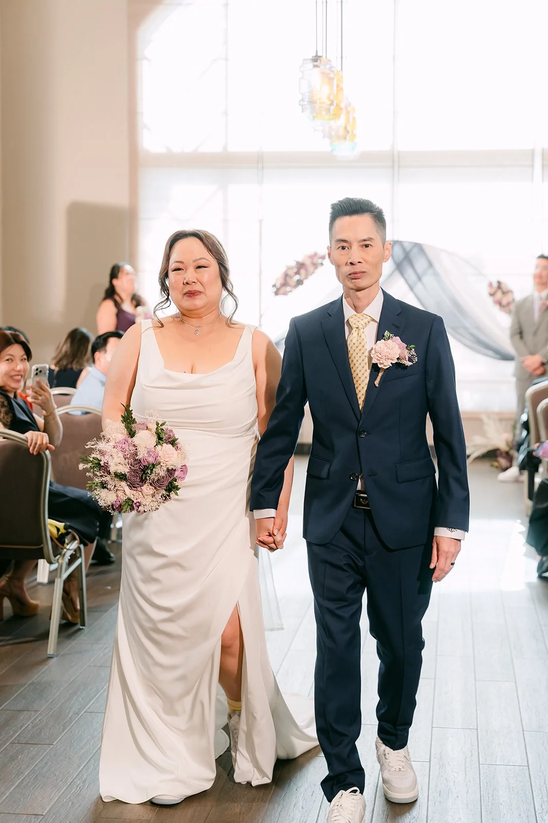 Mai and Bobby walking back up the aisle.