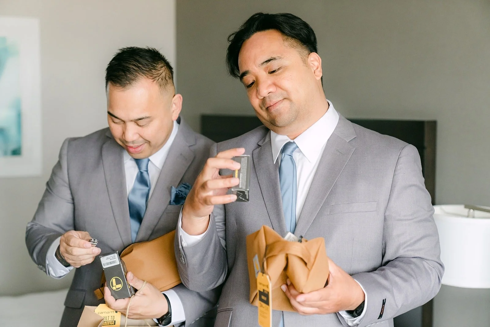 Two groomsmen checking out their gifts, photographed by One and Only Production