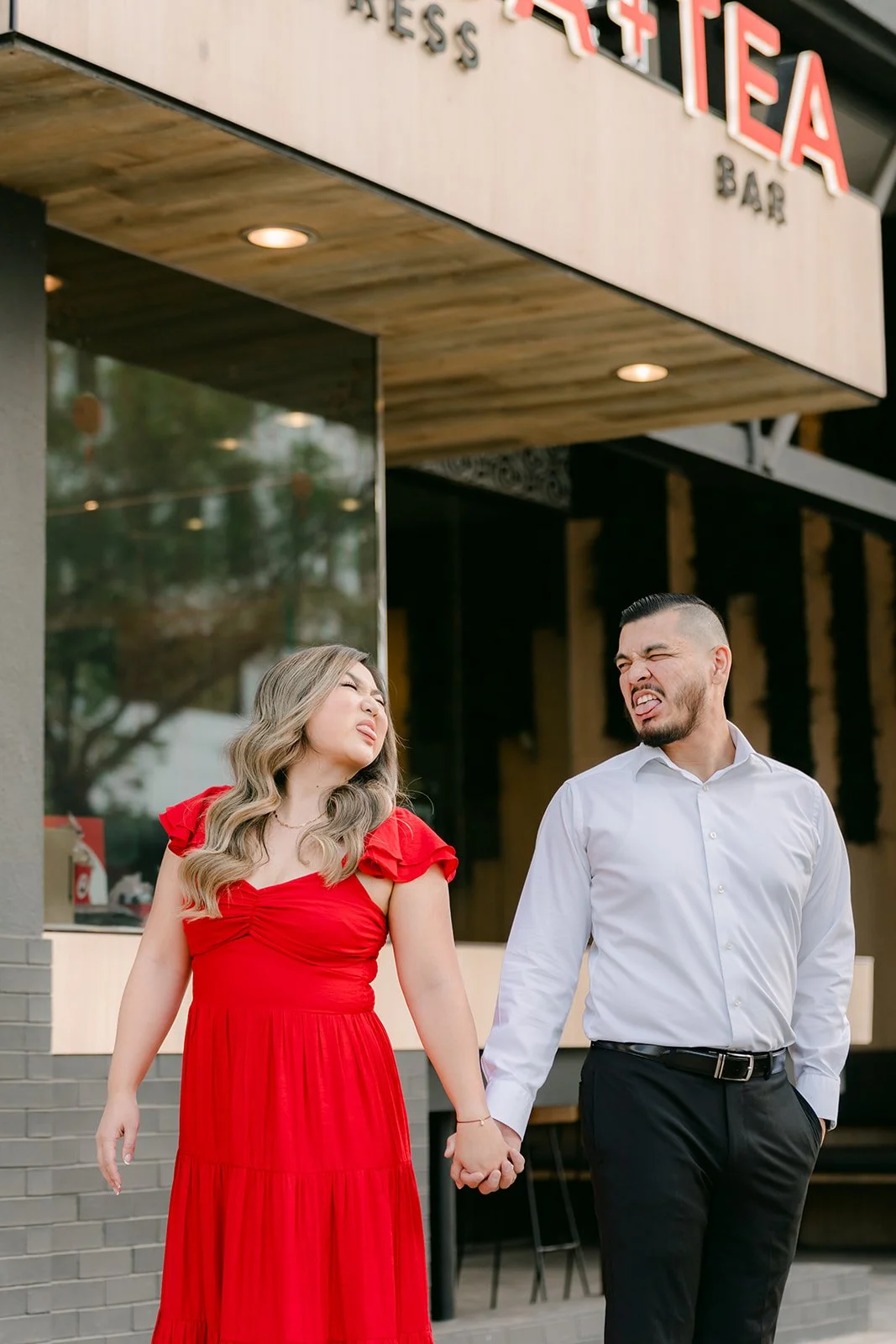 Linh and Ankush walk hand in hand outside the restaurant.