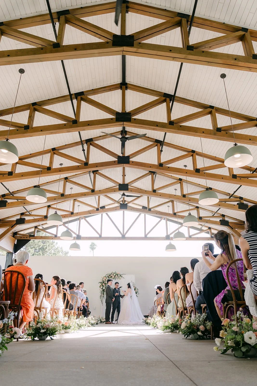 Wide view of the Colony House Pavilion ceremony aisle under the trusses