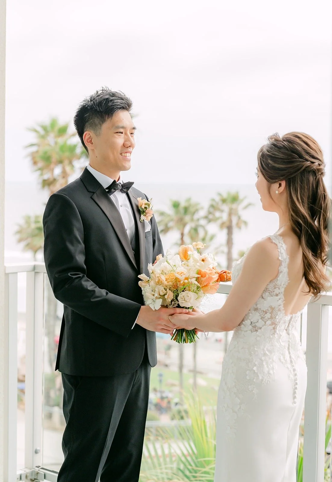 Angela tapping Eli on the shoulder for their first look on the ocean view balcony