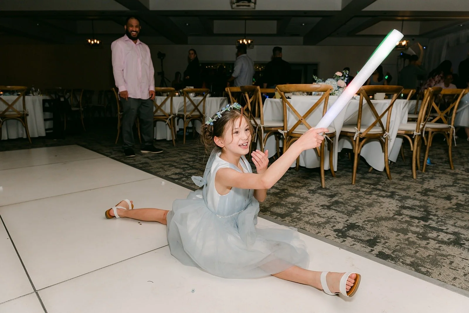 A bridesmaid dancing on the floor with a light stick